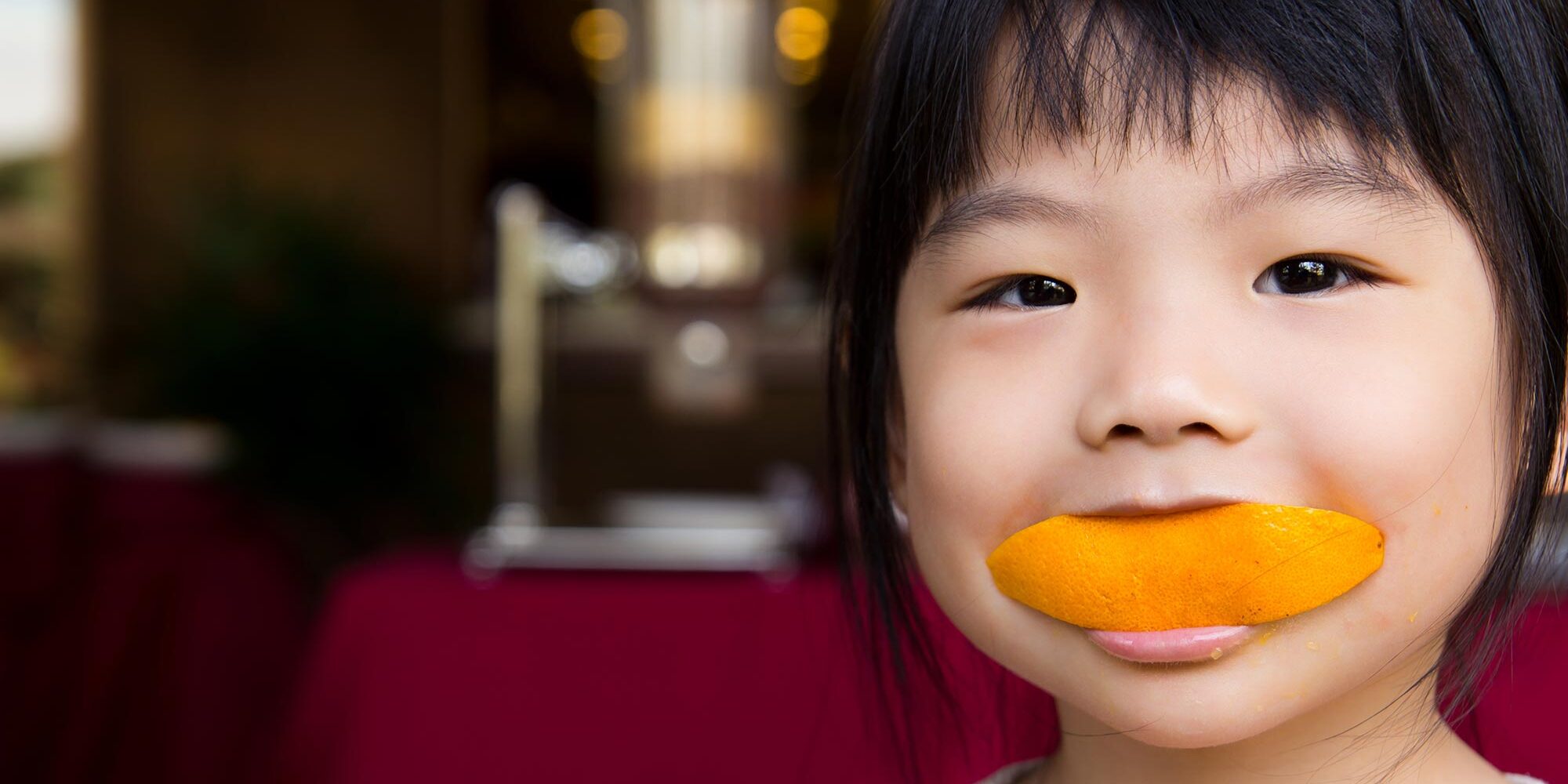 Child eating an orange