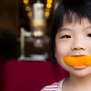 Child eating an orange