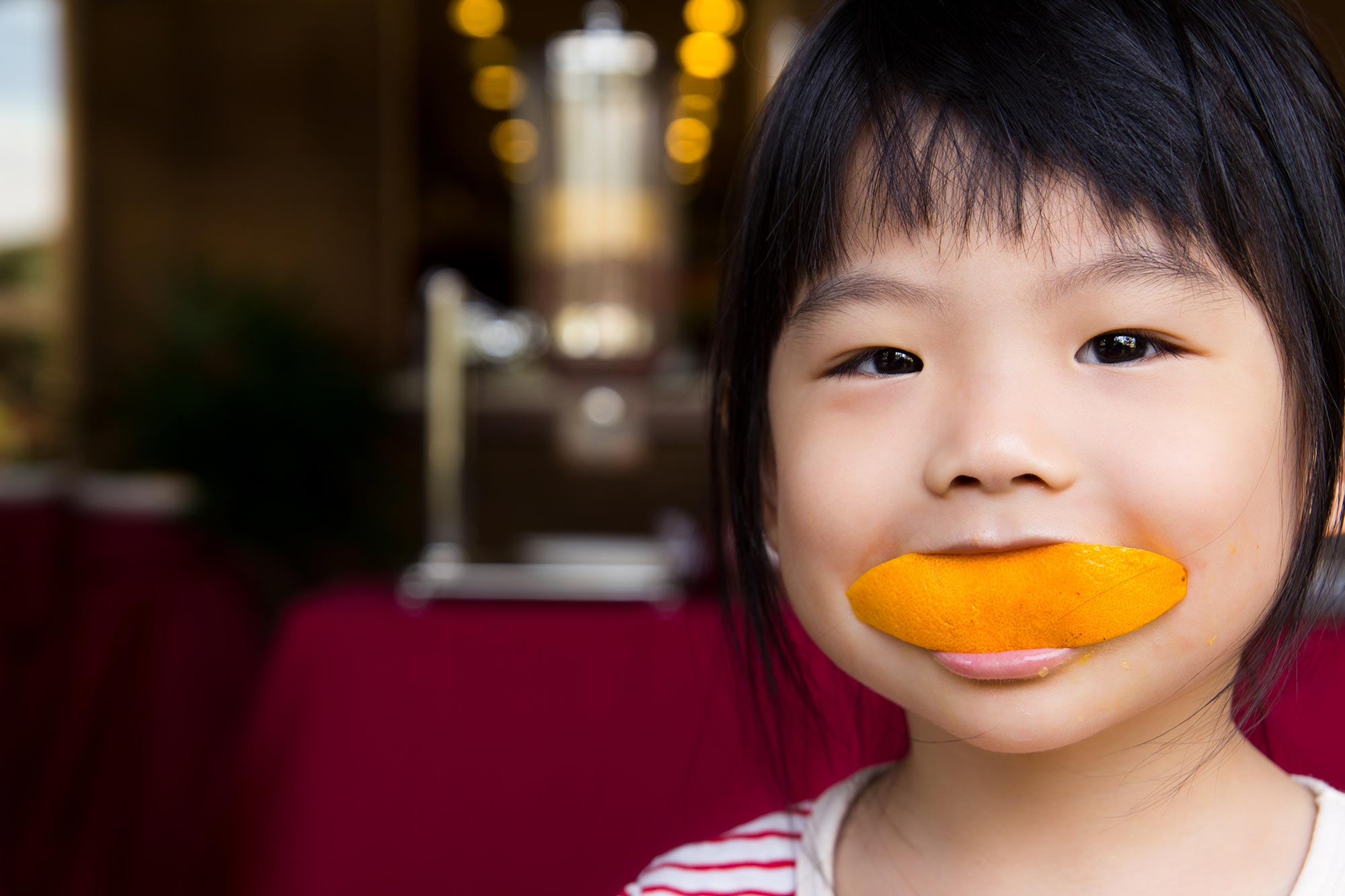 Child eating an orange