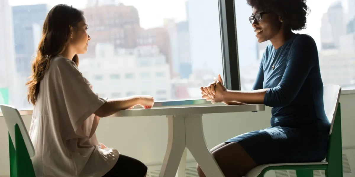 Two women conversing in a cafe