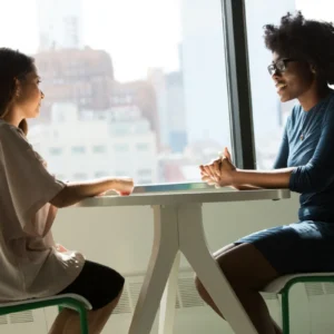 Two women conversing in a cafe