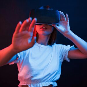 Woman wearing a virtual reality headset and reaching toward the camera