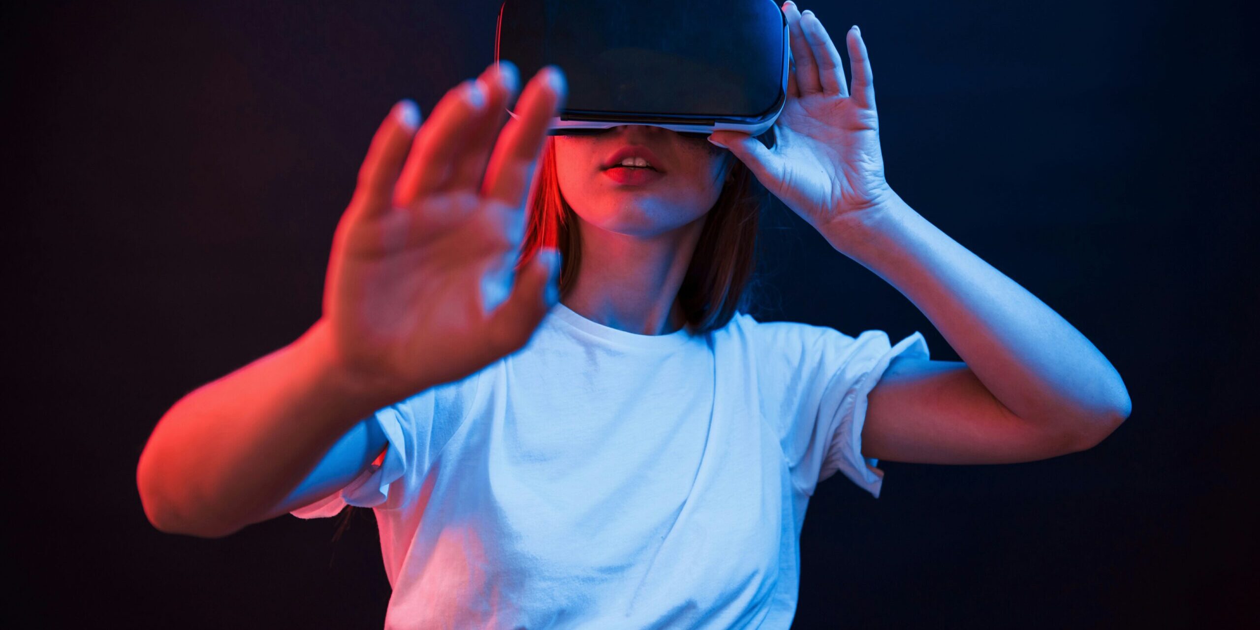 Woman wearing a virtual reality headset and reaching toward the camera