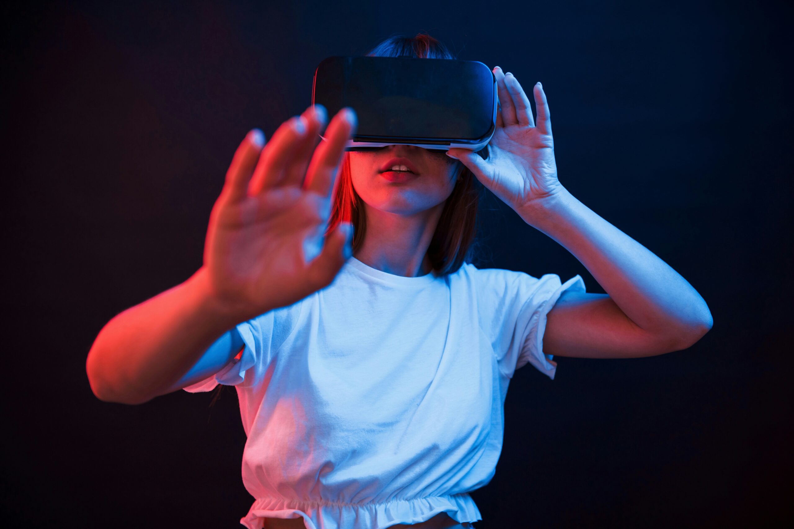Woman wearing a virtual reality headset and reaching toward the camera