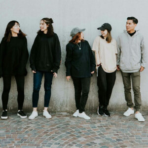 Group of young adults standing in a line facing the camera