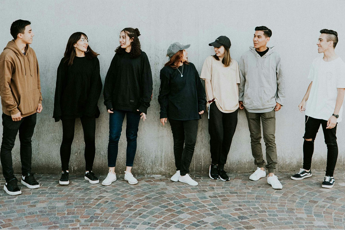 Group of young adults standing in a line facing the camera